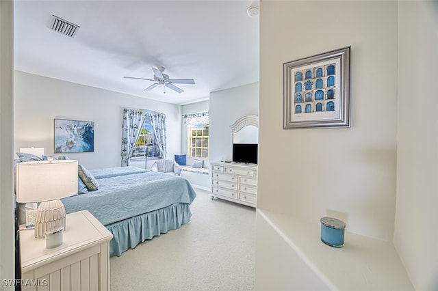 carpeted bedroom featuring visible vents and ceiling fan