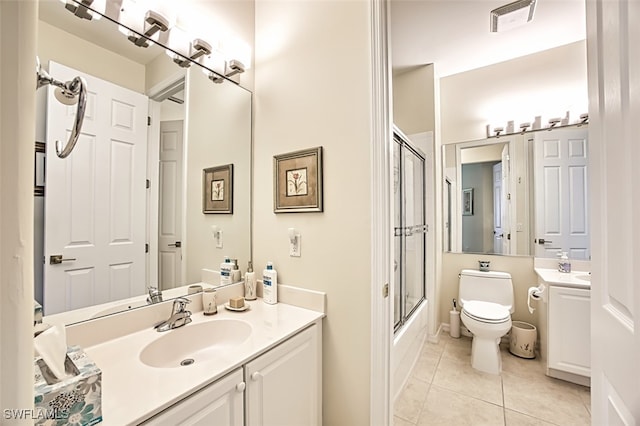 bathroom with vanity, visible vents, enclosed tub / shower combo, tile patterned flooring, and toilet