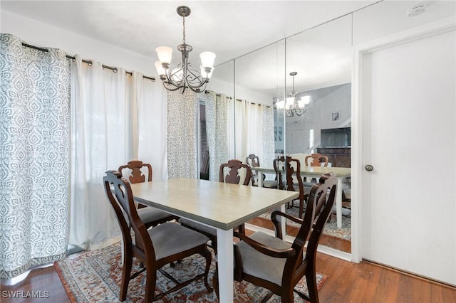 dining room with a chandelier and wood finished floors