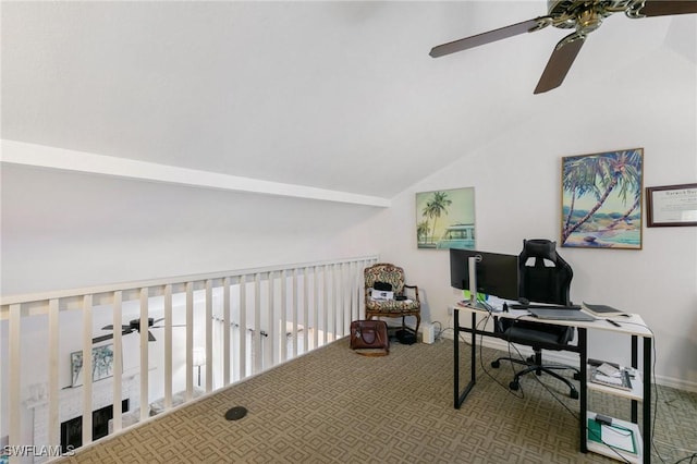 carpeted office with a ceiling fan and vaulted ceiling