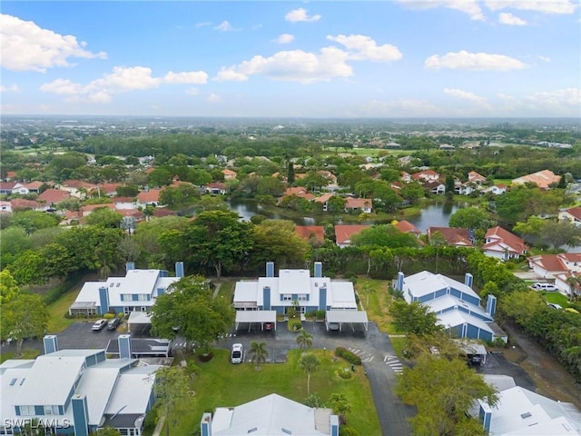 drone / aerial view featuring a residential view and a water view