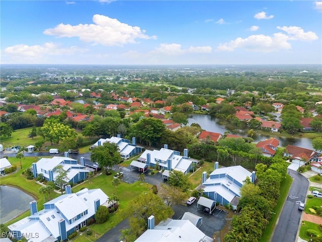 drone / aerial view with a residential view and a water view