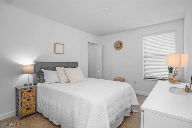 carpeted bedroom featuring baseboards