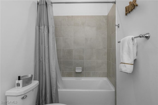 bathroom with shower / bathtub combination with curtain and toilet