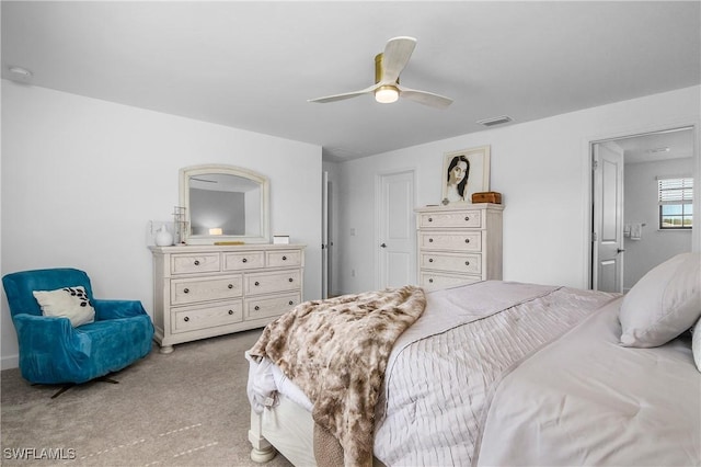 bedroom featuring a ceiling fan, visible vents, and light carpet