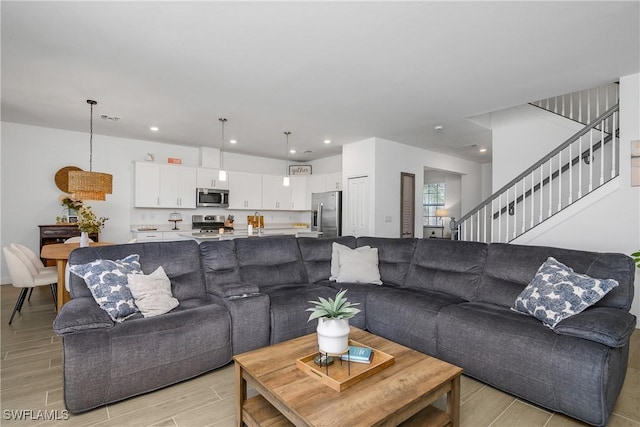 living room with recessed lighting, stairway, visible vents, and wood tiled floor