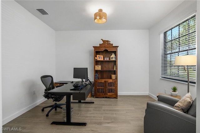 office with visible vents, baseboards, and wood finished floors