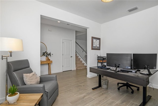 office area featuring visible vents, baseboards, and wood finished floors