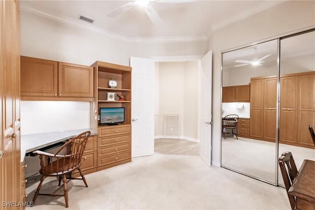 office with visible vents, light carpet, ceiling fan, and ornamental molding