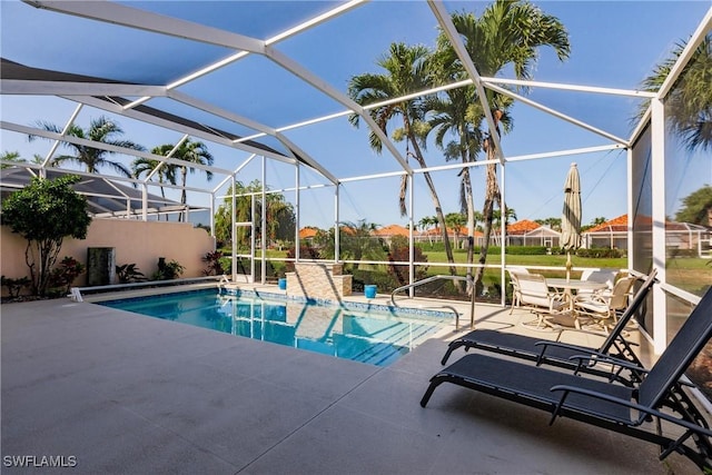 pool with a lanai and a patio area