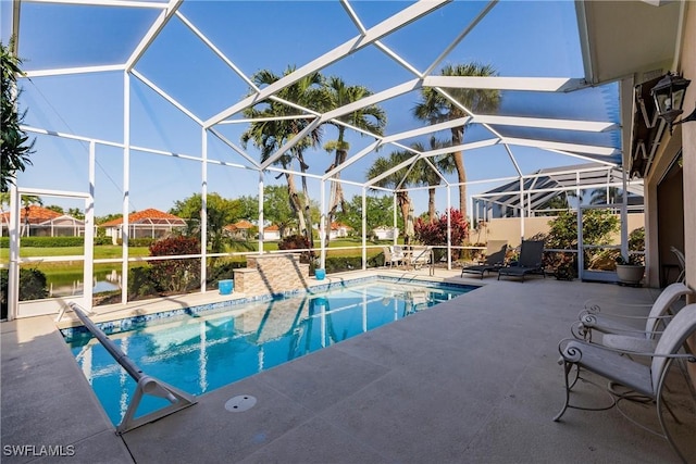 pool with glass enclosure and a patio