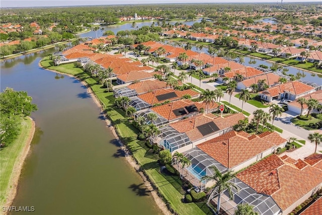 birds eye view of property with a residential view and a water view