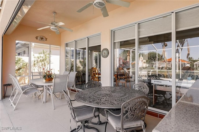 view of patio with outdoor dining space and a ceiling fan