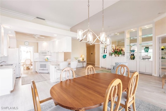 dining space featuring light wood finished floors, visible vents, ornamental molding, ceiling fan with notable chandelier, and recessed lighting