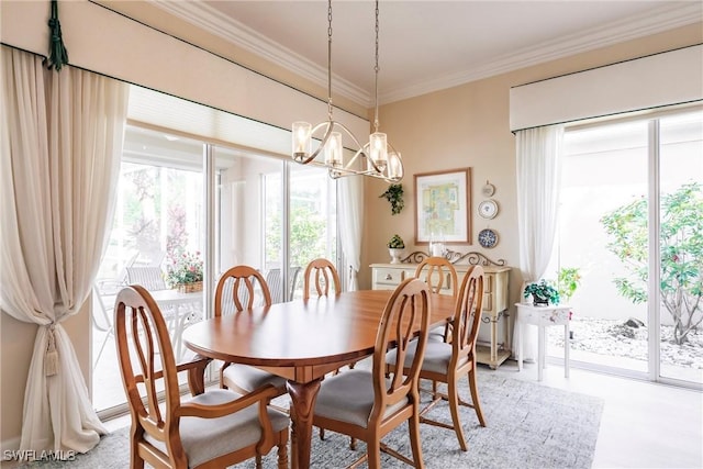 dining area featuring crown molding and a notable chandelier