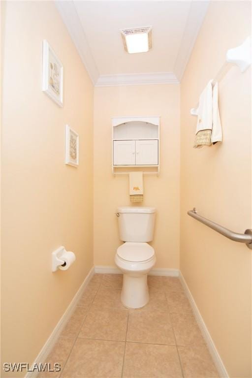 bathroom featuring baseboards, toilet, ornamental molding, and tile patterned flooring