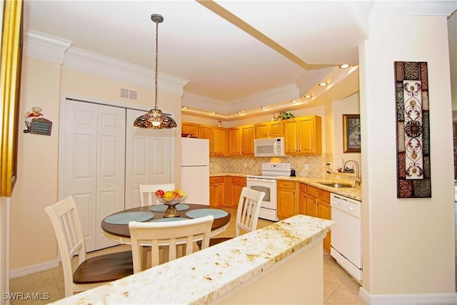 kitchen with white appliances, visible vents, ornamental molding, decorative backsplash, and a sink