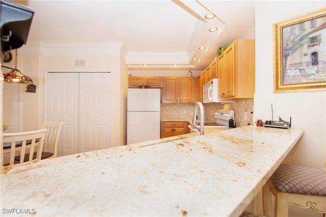 kitchen with white appliances, light stone countertops, recessed lighting, crown molding, and tasteful backsplash