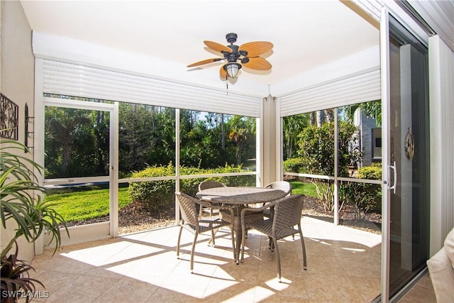 sunroom featuring plenty of natural light and a ceiling fan