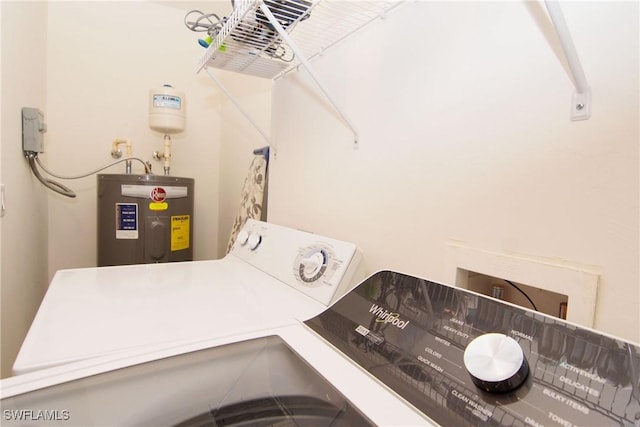 clothes washing area with water heater, laundry area, and washing machine and clothes dryer