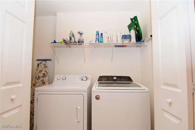 clothes washing area featuring laundry area and washer and clothes dryer