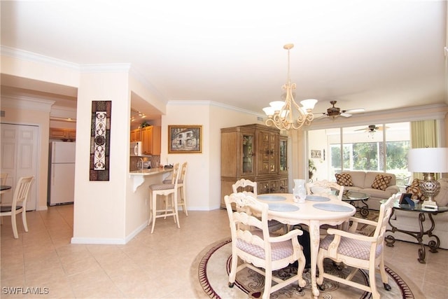 dining area with baseboards, light tile patterned flooring, and crown molding