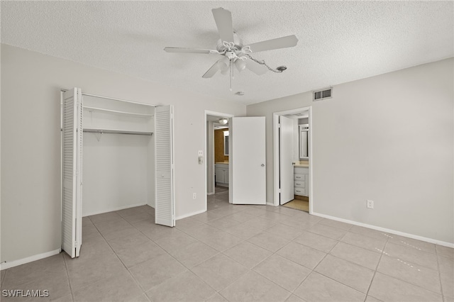 unfurnished bedroom with baseboards, visible vents, light tile patterned flooring, a closet, and a textured ceiling