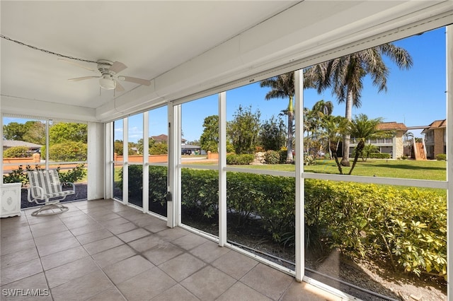 unfurnished sunroom featuring a healthy amount of sunlight and ceiling fan