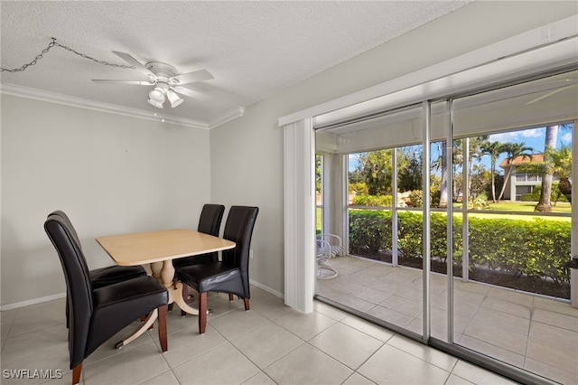 dining area featuring a textured ceiling, a healthy amount of sunlight, and crown molding