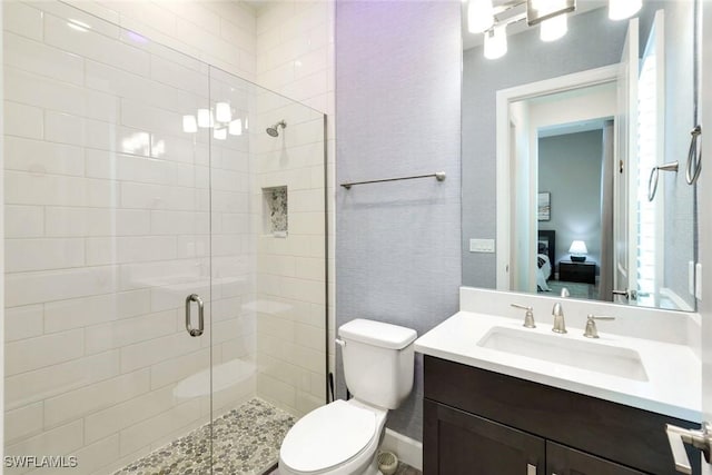 full bathroom with a shower stall, toilet, and vanity