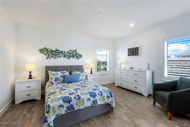 bedroom with recessed lighting, baseboards, and wood finished floors