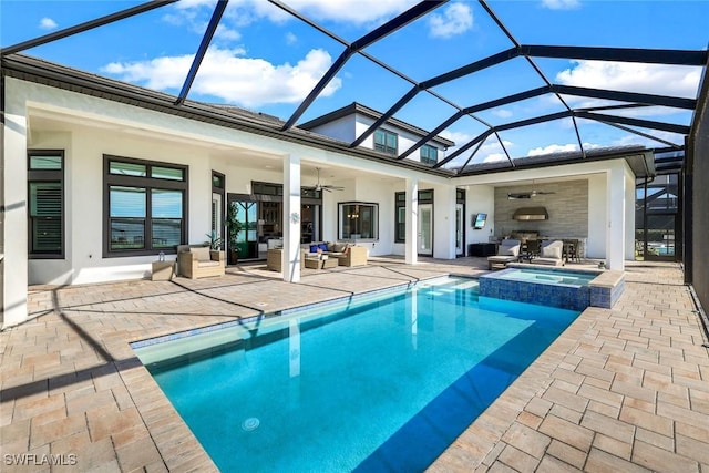 view of pool with glass enclosure, a ceiling fan, an outdoor living space, a pool with connected hot tub, and a patio area