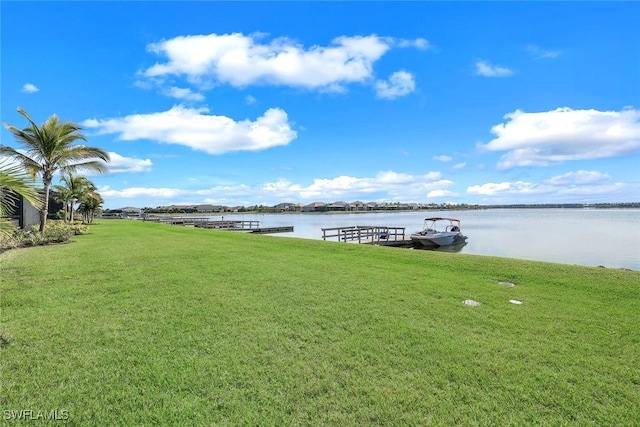 dock area featuring a water view and a lawn