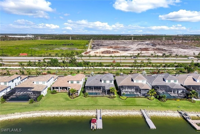 drone / aerial view featuring a residential view and a water view