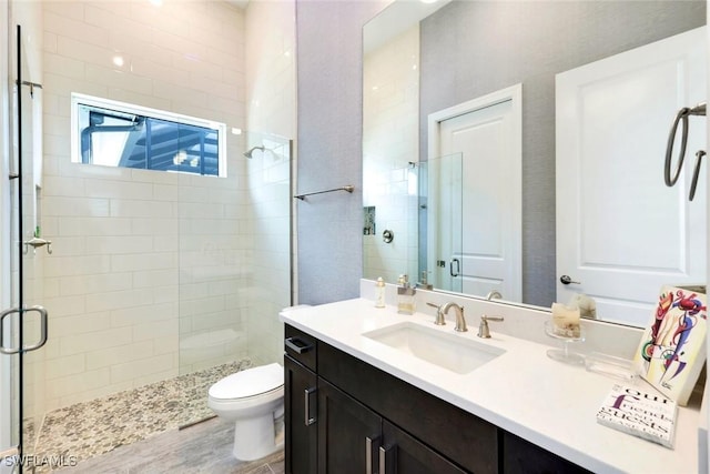 full bath featuring a shower stall, toilet, and vanity