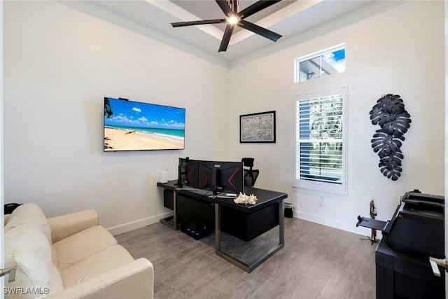 office with baseboards, wood finished floors, and a ceiling fan