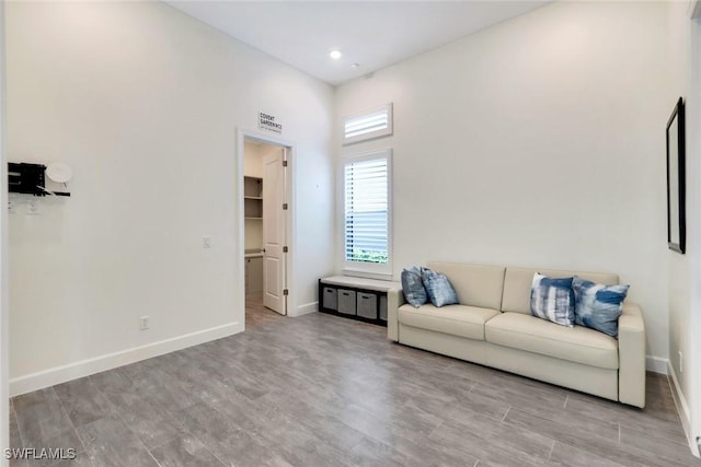 living area featuring visible vents, baseboards, and wood finished floors