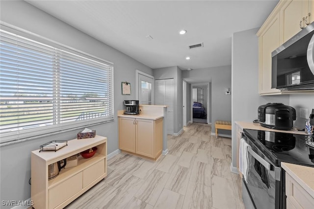 kitchen with visible vents, black electric range oven, stainless steel microwave, recessed lighting, and light countertops