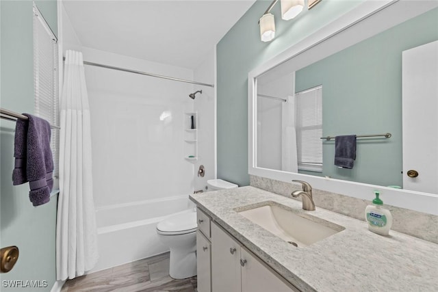 bathroom with toilet, vanity, and shower / tub combo