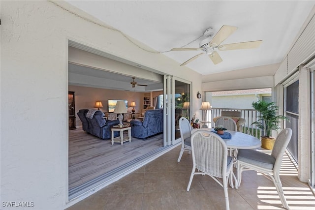 sunroom / solarium with french doors and a ceiling fan