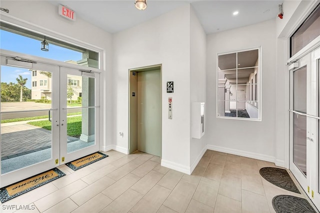 doorway with recessed lighting, french doors, elevator, and baseboards