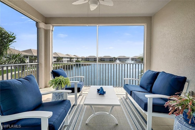 sunroom / solarium with plenty of natural light, a water view, and ceiling fan