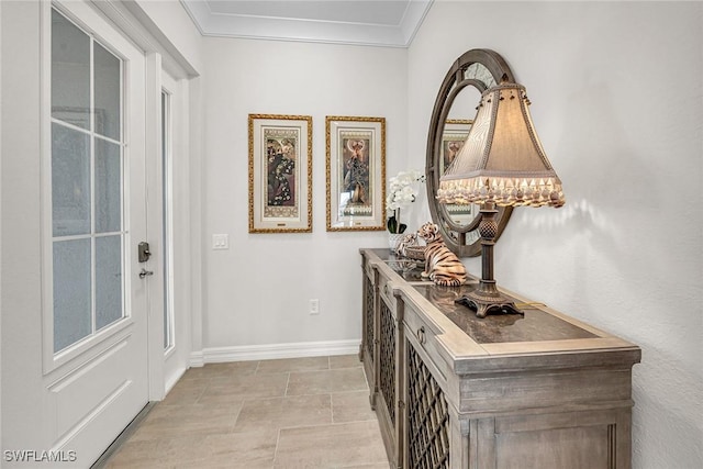 hallway featuring baseboards and crown molding