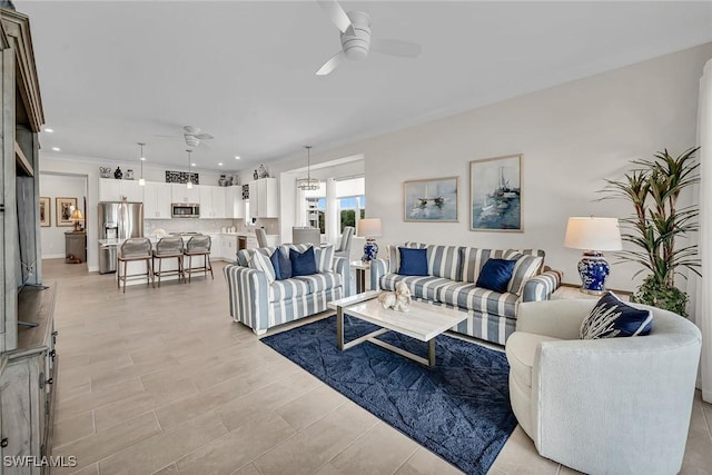 living area featuring recessed lighting and a ceiling fan