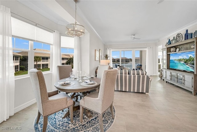 dining space with a chandelier, baseboards, and ornamental molding