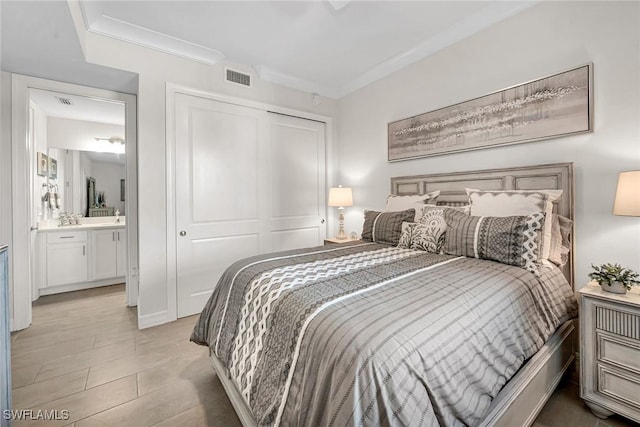 bedroom featuring visible vents, a closet, and ornamental molding