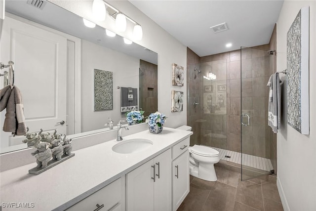 bathroom featuring visible vents, toilet, a stall shower, tile patterned flooring, and vanity