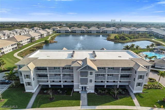 drone / aerial view featuring a water view and a residential view