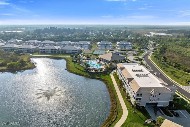 drone / aerial view with a water view and a residential view