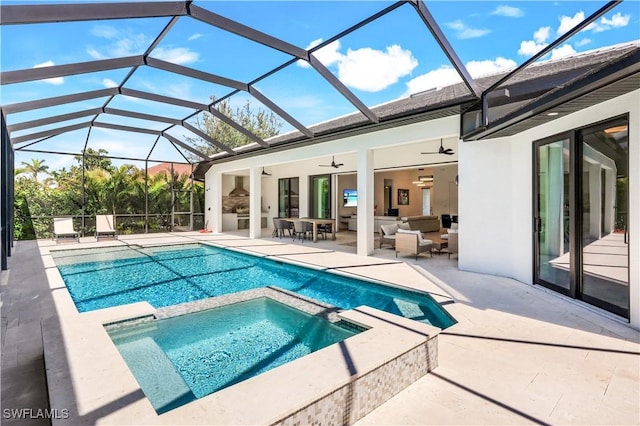 view of swimming pool featuring a patio area, a pool with connected hot tub, outdoor lounge area, and ceiling fan